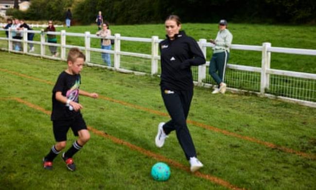 Grace Clinton joining in with the children attending a Fun Football coaching session held at Bollington FC in Cheshire.